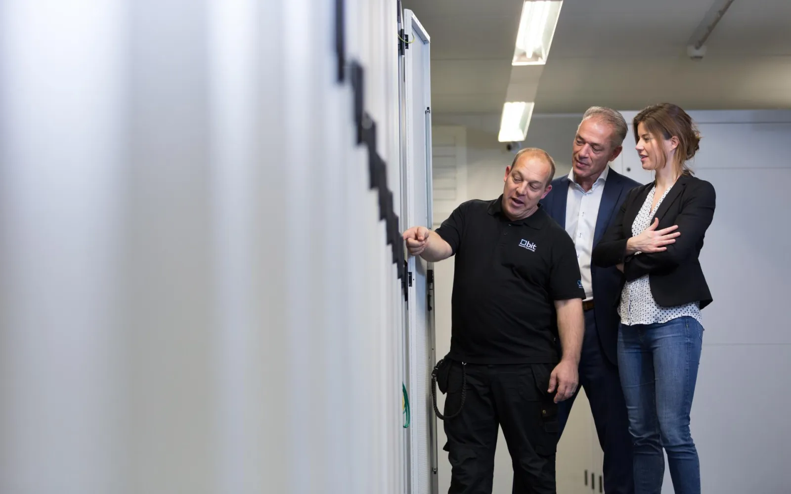 BIT engineer walking visitors through a server rack